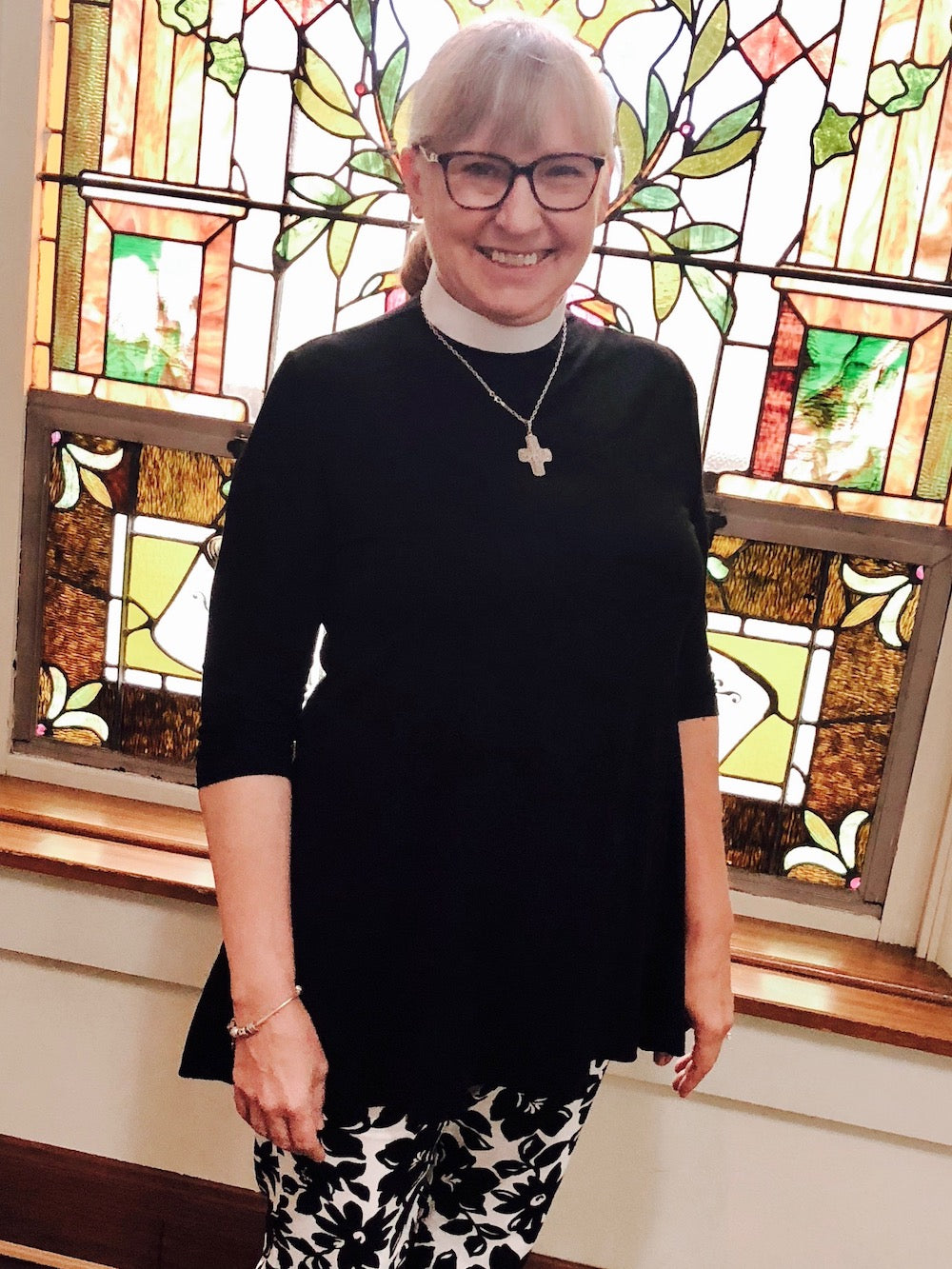 clergywoman in swing tunic round collar black and white pants